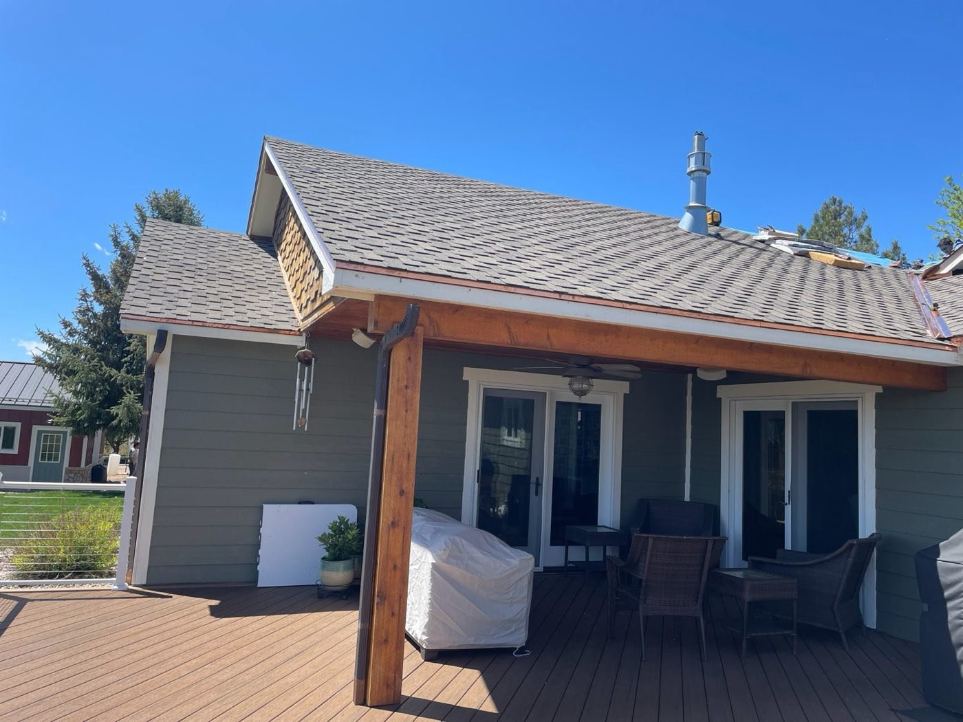 New shingle roof and covered porch on a Colorado home finished by Crazy Horse Roofing